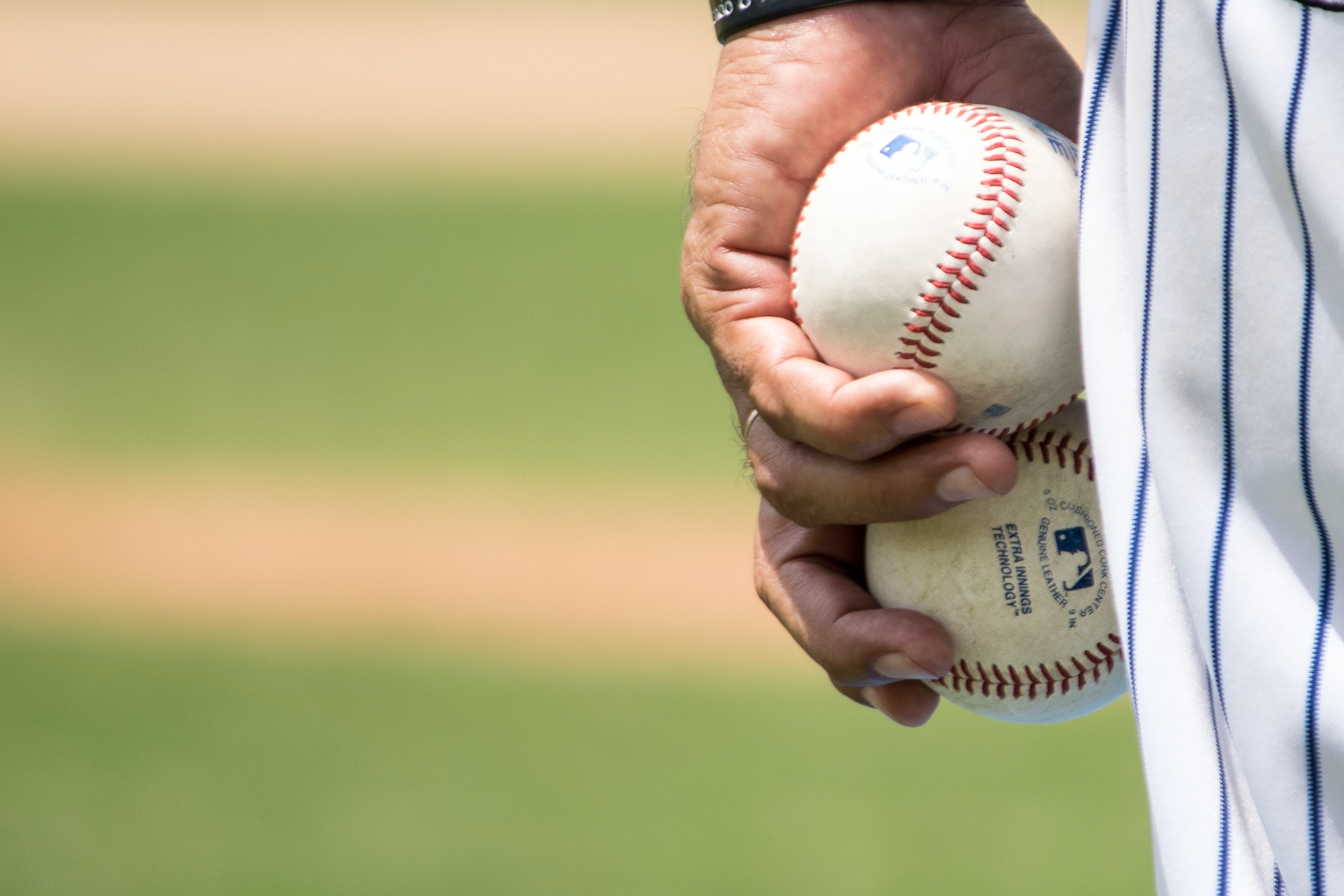 pitcher holding baseball, close up